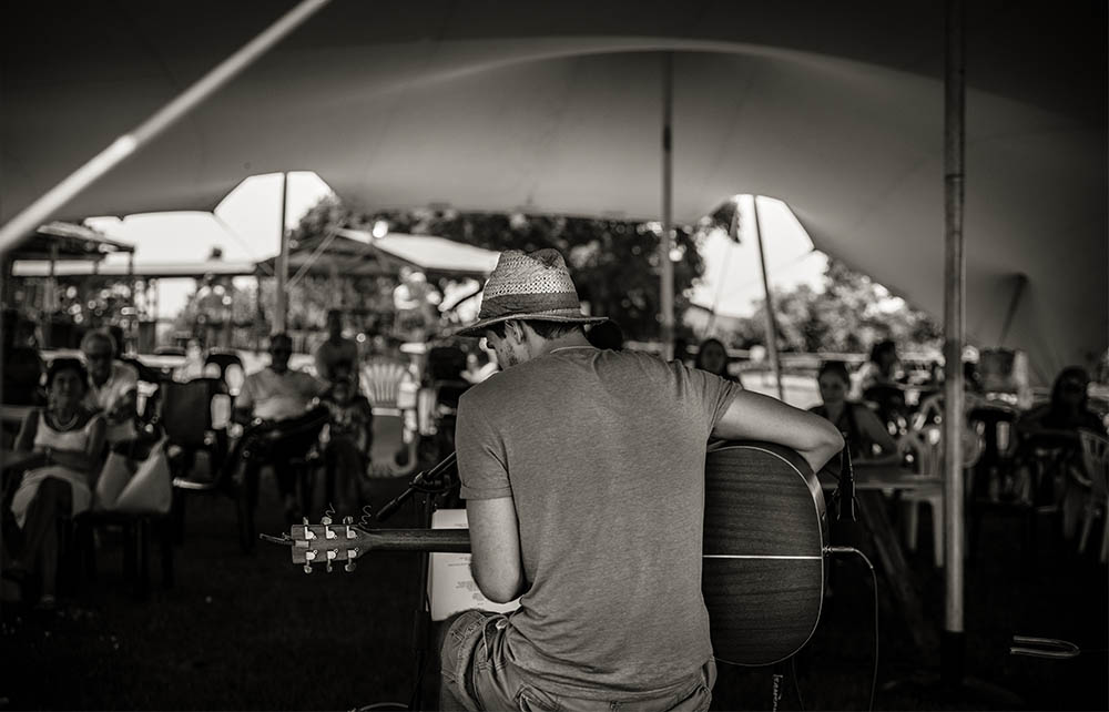 Shongweni farmers market South Africa with local musician playing accordion