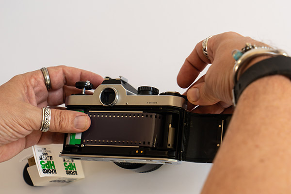 How to load film into a camera - wind the film on a little to ensure film has 'caught'