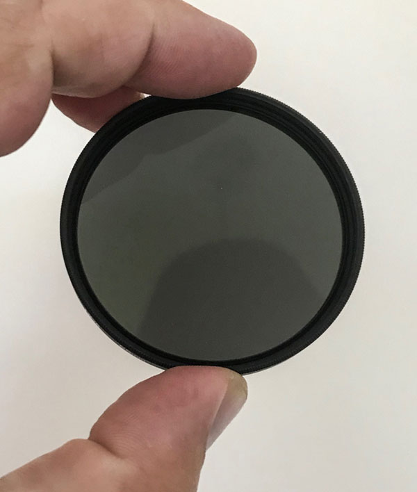 Tim holding Neutral density filter (ND) used to photograph the jurassic coast