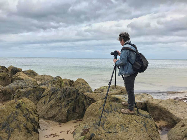 Tim photographing on rocky pier in Norfolk